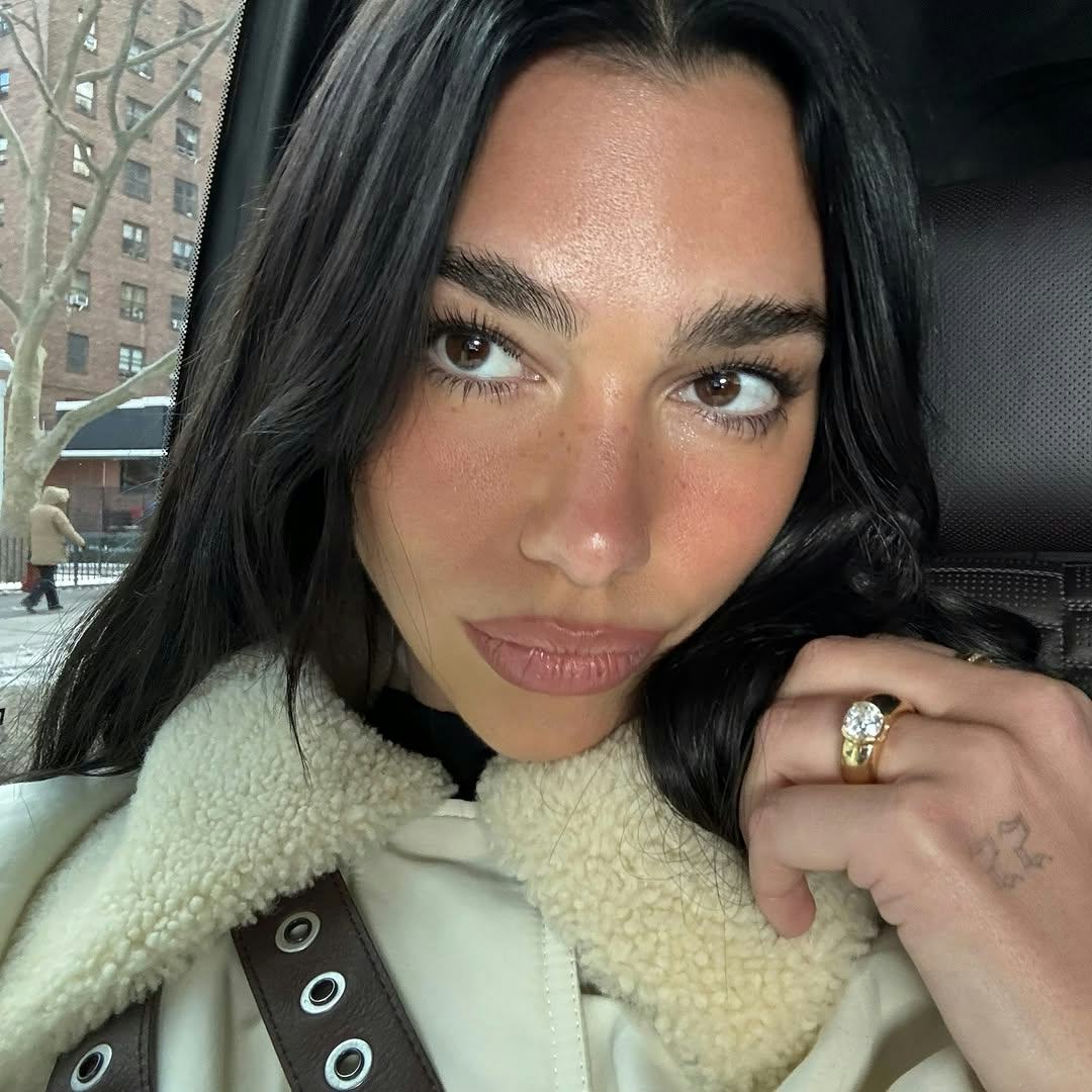 Dua Lipa in a selfie with luminous skin.