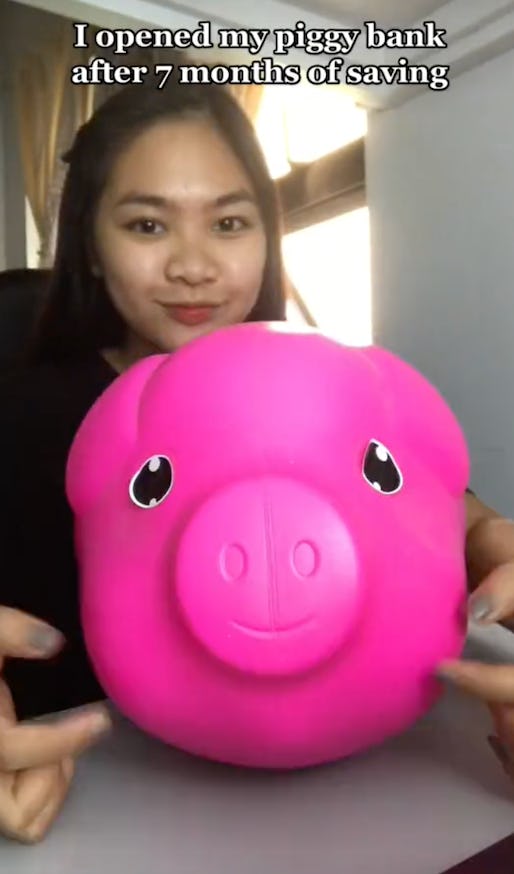 Saving money using a piggy bank.