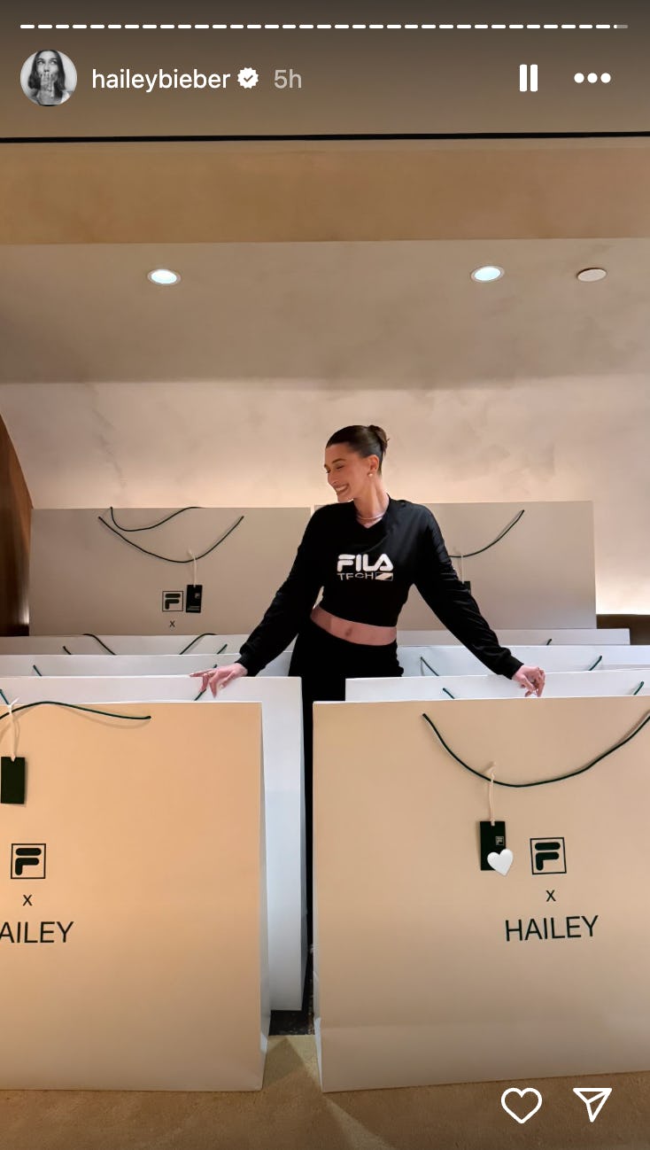 Hailey Bieber wears a FILA crop top and maxi skirt.