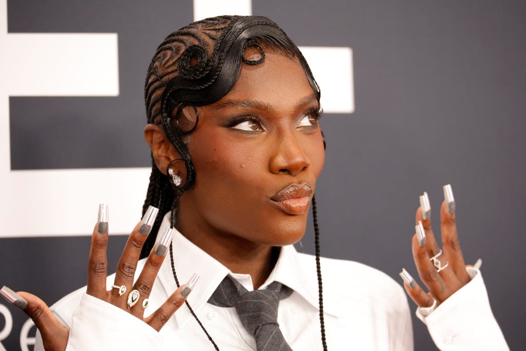 Doechii arrives at the 67th Annual Grammy Awards with a Thom Browne themed mani.