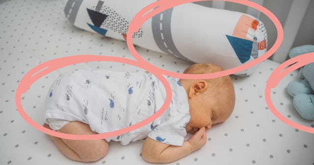 A baby sleeps on its stomach in a crib filled with pillows and stuffed animals. A new study has foun...