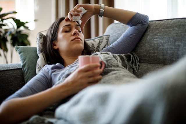 Sick woman lying in bed