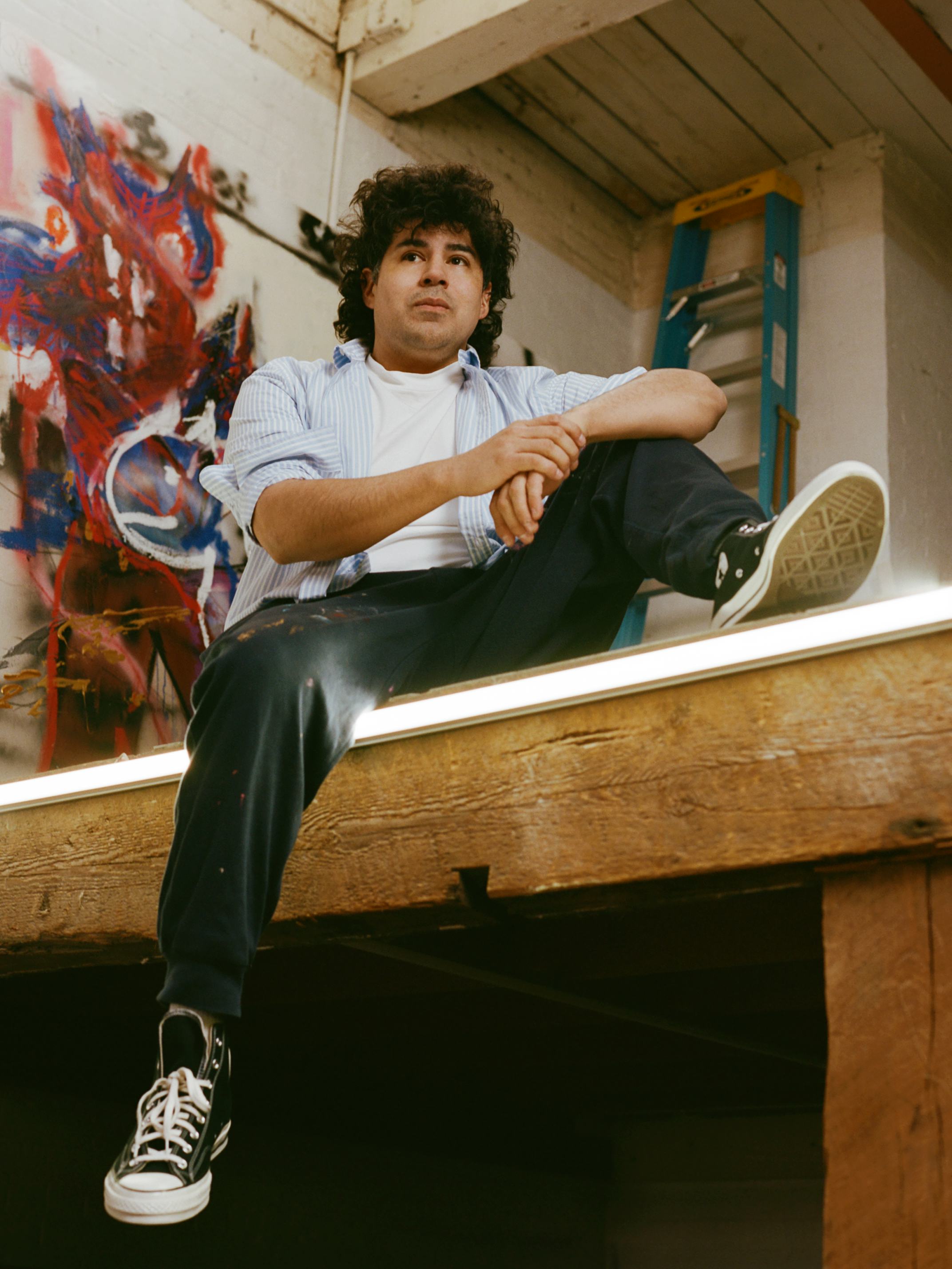 Robert Nava in his studio in Brooklyn. He wears a Brooks Brothers shirt; The Row t-shirt; Converse s...