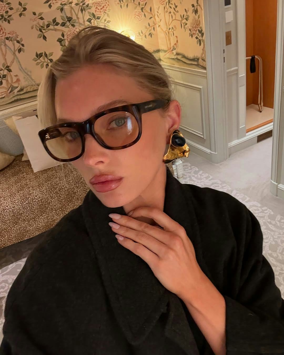 Elsa Hosk wears a trench coat.