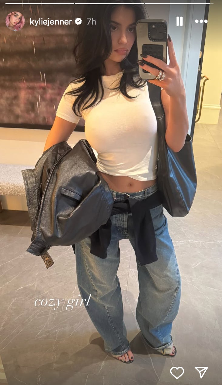 Kylie Jenner wears a white T-shirt and jeans.