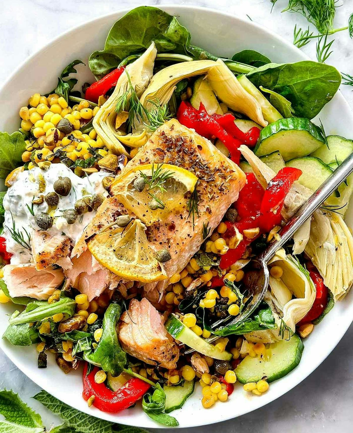Mediterranean salmon bowls with fresh veggies and herbs, an idea for easy salmon recipes