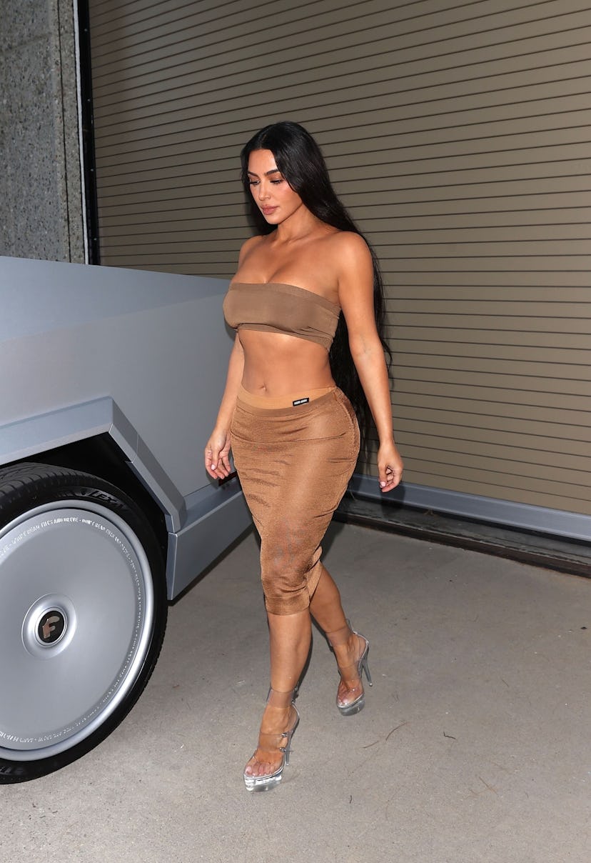 Kim Kardashian wears a bandeau bra and skirt.