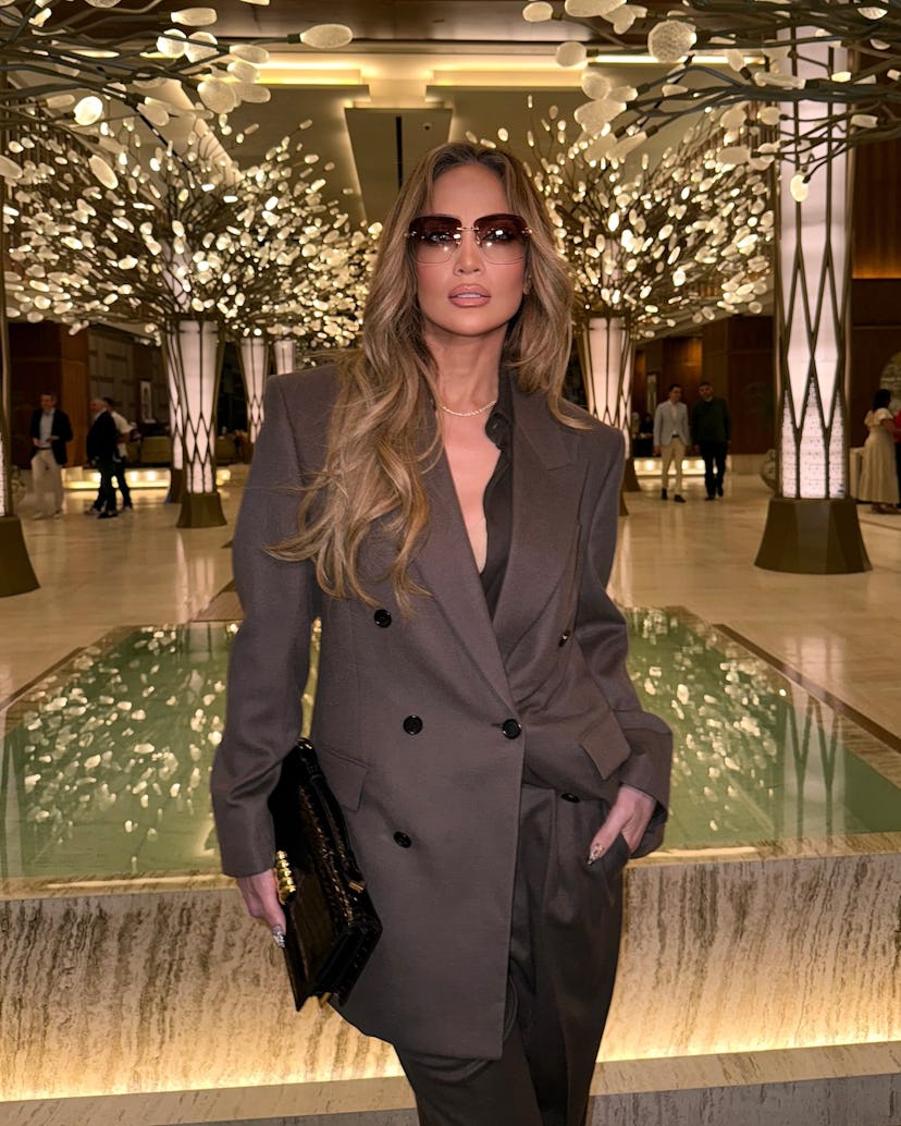J.Lo wore a plunging suit to promote her bestie’s book.