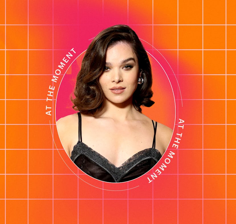 An image features a woman with wavy hair, wearing a black, stylish outfit, set against a bright oran...
