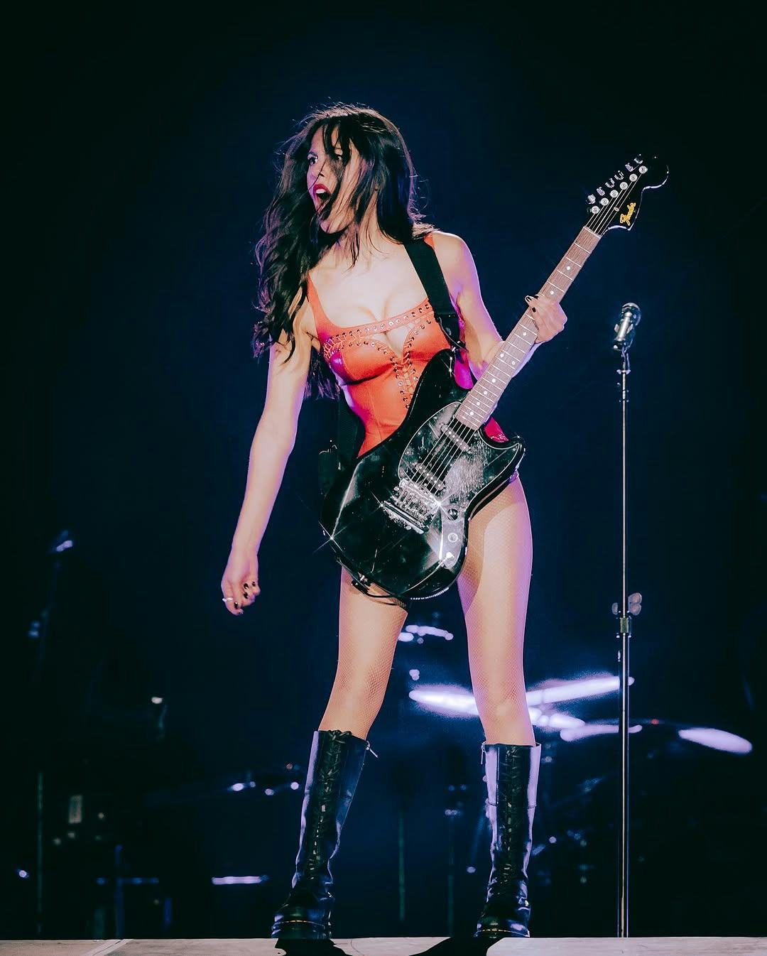 Olivia Rodrigo wears a red leather bodysuit.  