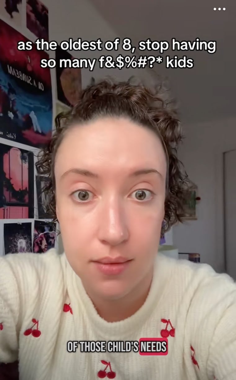 A person with curly hair wearing a cherry-patterned sweater looks directly at the camera, expressing their frustration with a humorous caption about parenting challenges.