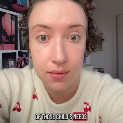 A person with curly hair wearing a cherry-patterned sweater looks directly at the camera, expressing their frustration with a humorous caption about parenting challenges.