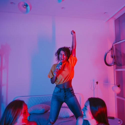 Girls asking each other the best truth or dare questions on a girls' night in