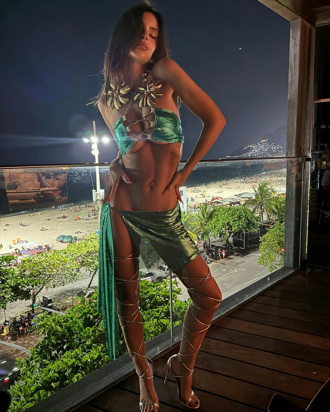 Emily Ratajkowski wore a metallic green bra and cover up.