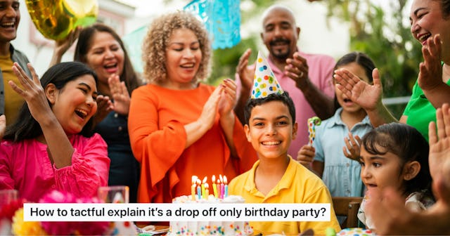 A young boy celebrates his birthday. He sits in front of a birthday cake surrounded by cheering fami...