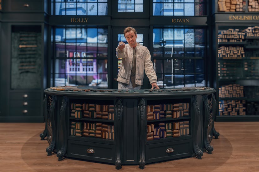 Tom Felton pointing a wand at the Harry Potter Shop Chicago