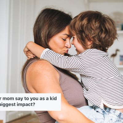 A woman holds her young child, and they smile into each other's faces.
