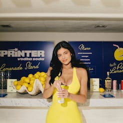 Kylie Jenner wore a yellow latex minidress and held a matching Sprinter vodka can at Coachella 2025.