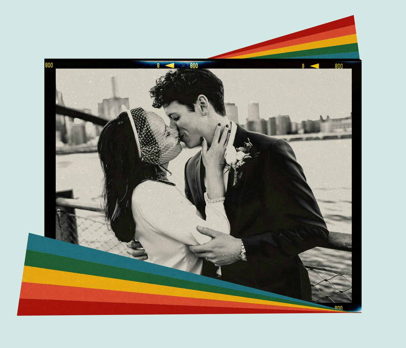 A queer couple kisses in front of a river on their wedding day