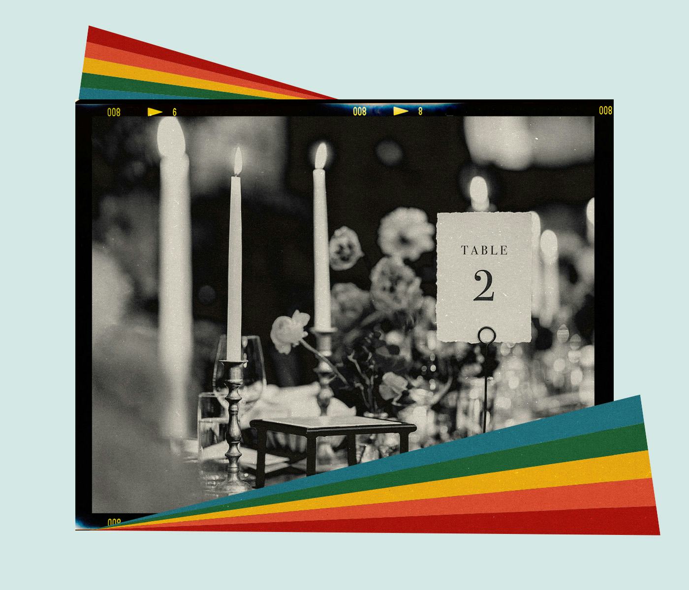 Lit taper candles and florals make up a wedding tablescape