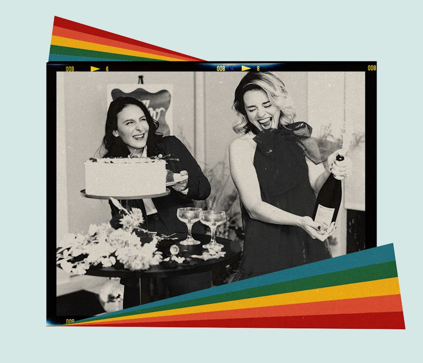 Two women pop champagne during their wedding reception