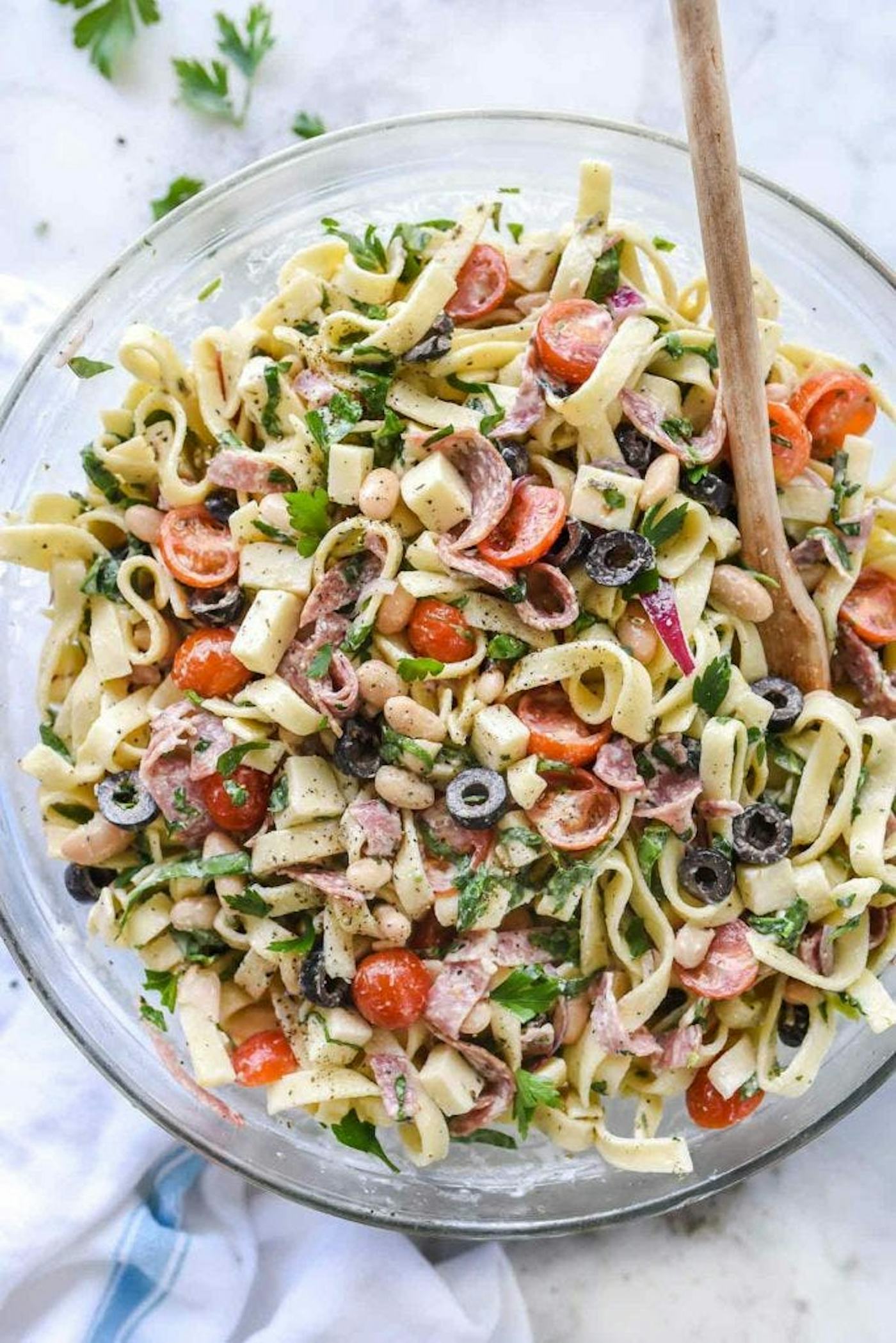 Pasta salad with egg noodles, olives, salami, and more in a story about egg noodle recipes