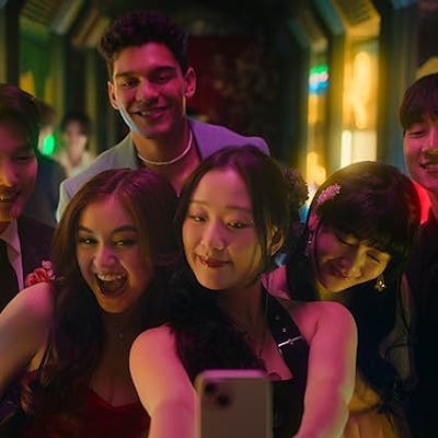 Teen take a group selfie, a still from the Netflix show 'XO Kitty.'