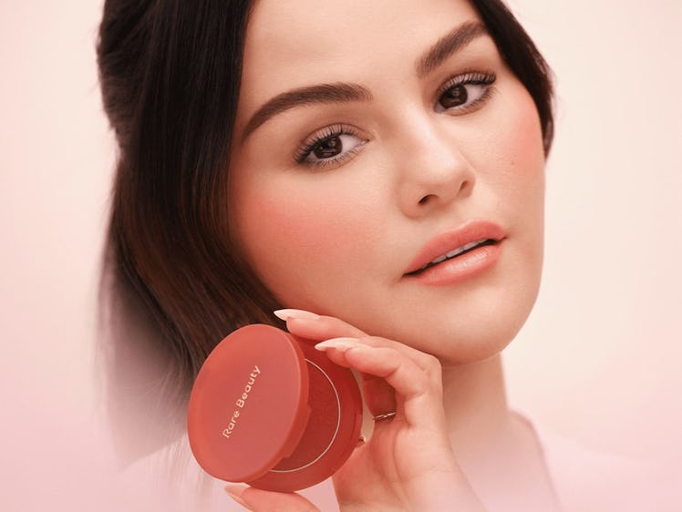 Selena Gomez holding Rare Beauty's Soft Pinch Bouncy Blush.