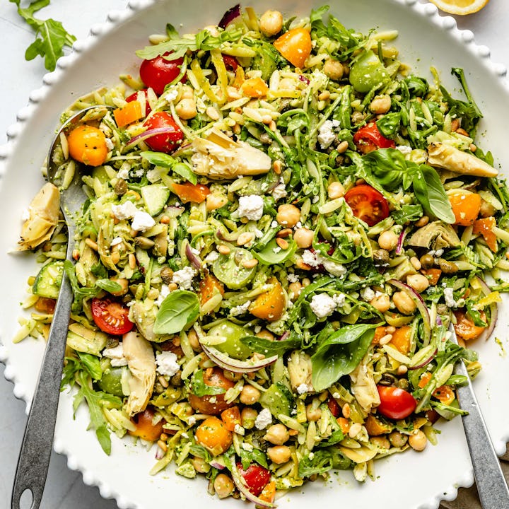 pesto orzo pasta salad in a white bowl, in a story about healthy orzo recipes