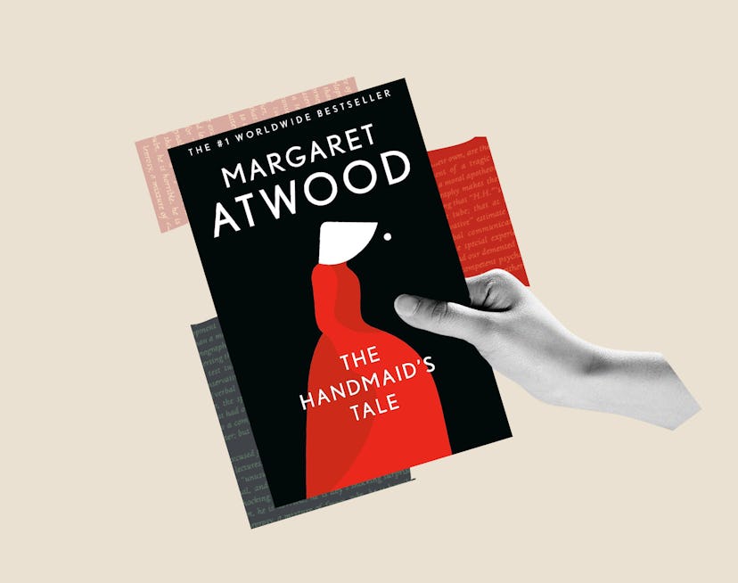 A hand holds the cover of Margaret Atwood's 'The Handmaid's Tale.'