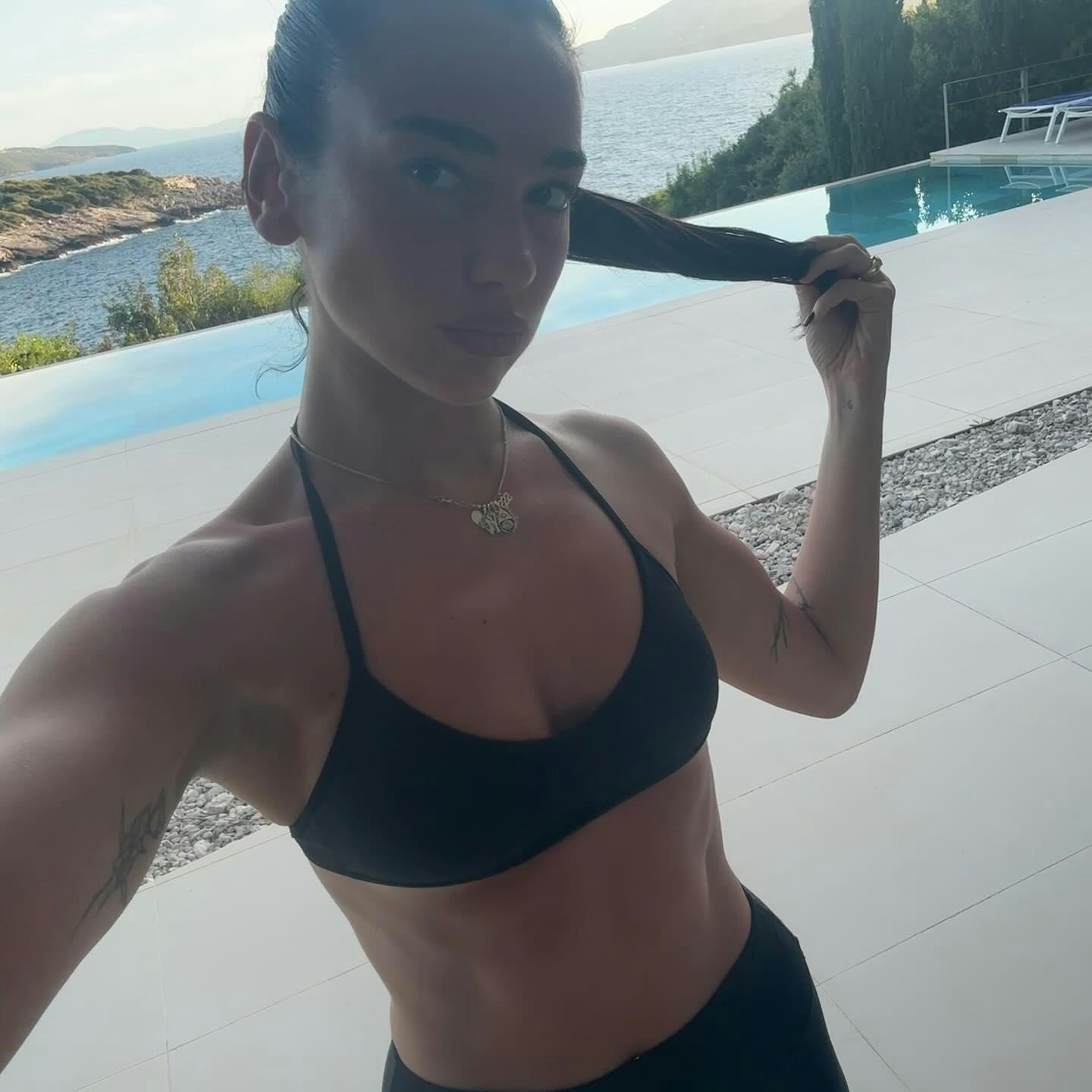 Dua Lipa wore multiple bikinis while vacationing with boyfriend Callum Turner.