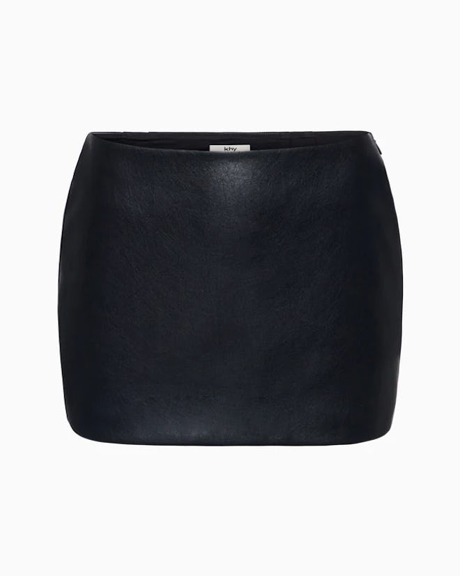 Kylie Jenner bared her navel in a crop top and leather mini.