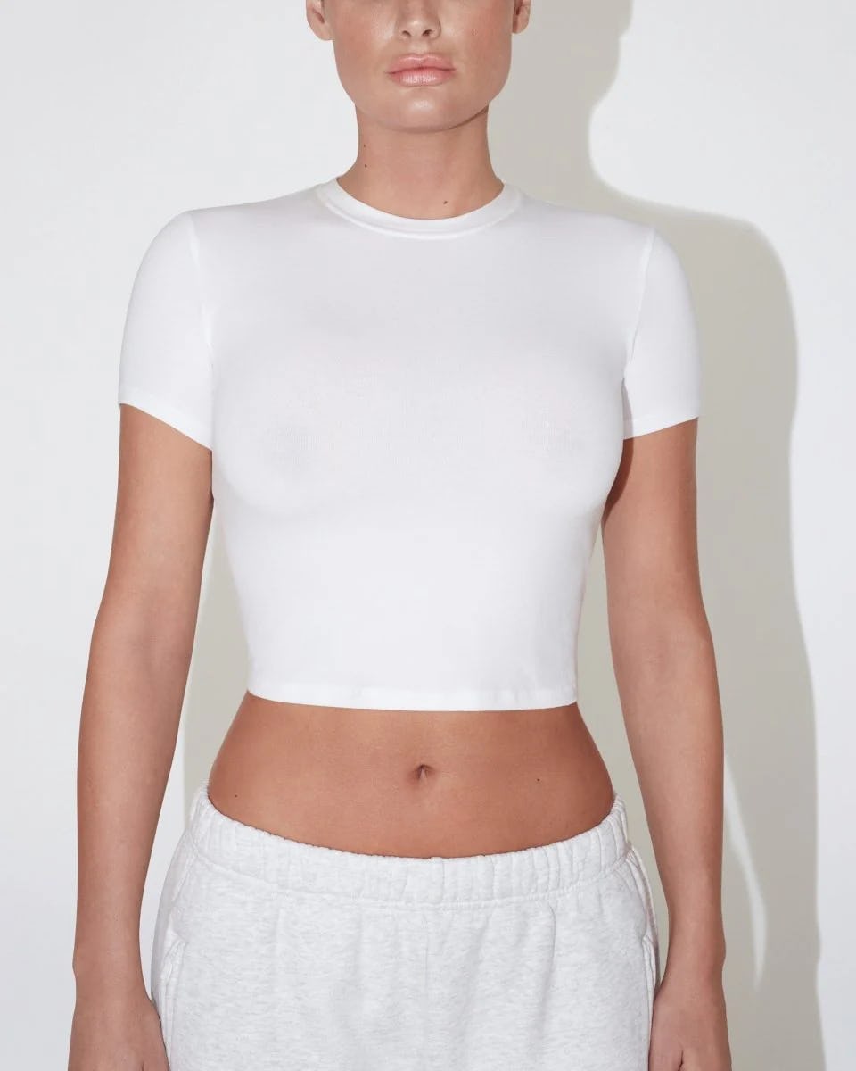 Kylie Jenner bared her navel in a crop top and leather mini.