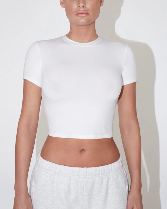 Kylie Jenner bared her navel in a crop top and leather mini.