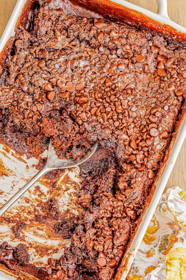 Chocolate cake covered in chocolate chips in a white 9x13 baking dish, in a story about easy chocola...