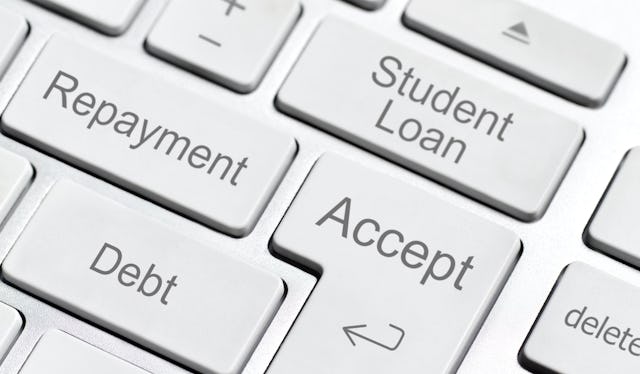 Close-up of a keyboard showing keys labeled "Debt," "Repayment," "Student Loan," and "Accept," highl...