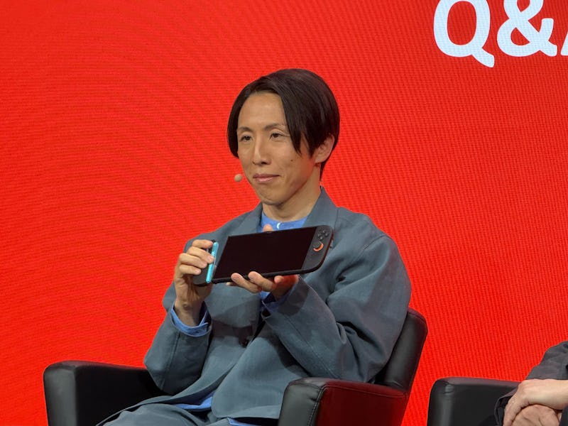 Kouichi Kawamoto holds up the Switch 2 at the New York City reveal event