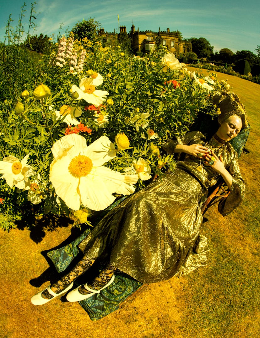 tilda swinton in a bed of flowers, photographed by tim walker
