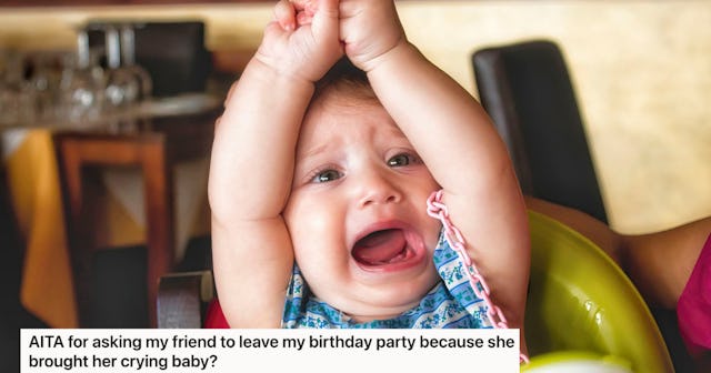 A distressed baby raises its arms while sitting in a high chair, expressing frustration.