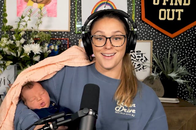 Kylie Kelce, wearing headphones and sitting in front of a microphone in front of a vibrant backgroun...