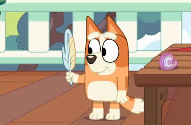 Bingo from 'Bluey' holding her feather wand, in a story answering the question, is bingo a boy or a ...