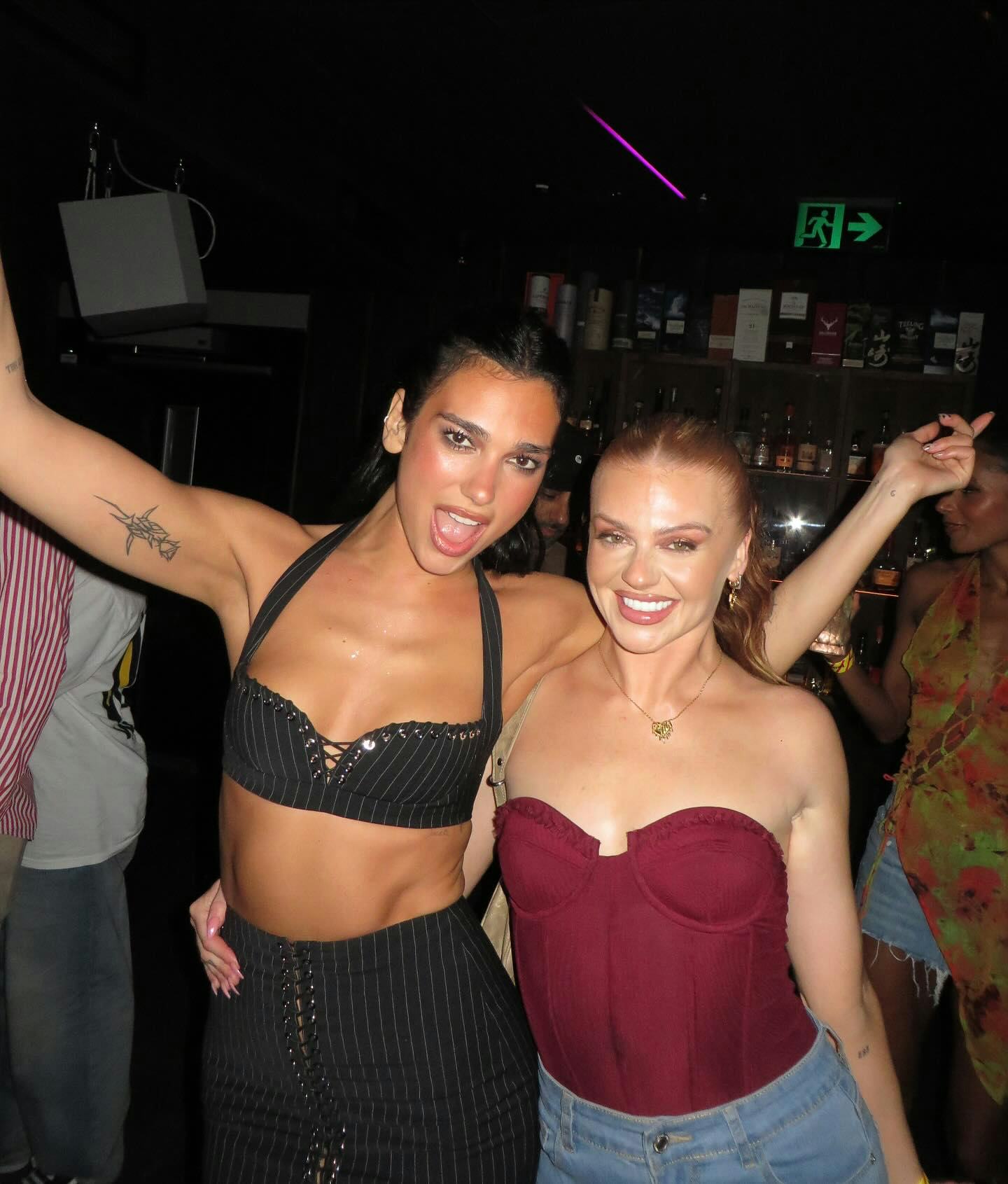 Dua Lipa wore a plunging pinstripe bra and lace-up skirt.