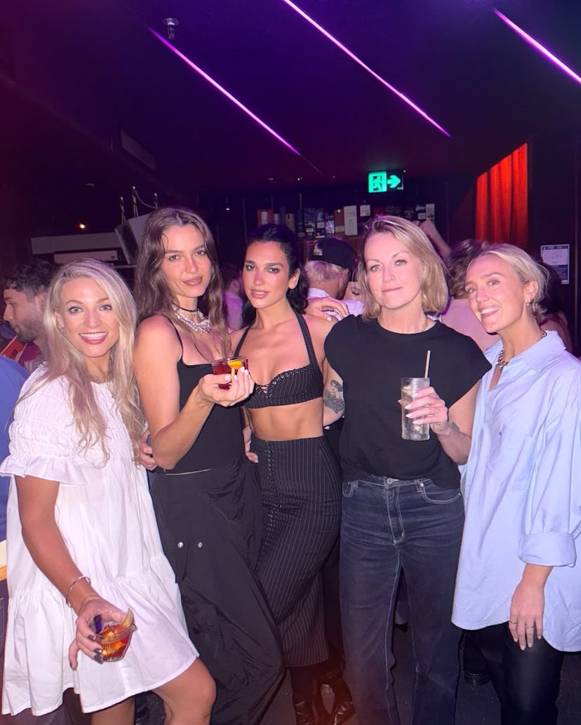 Dua Lipa wore a plunging pinstripe bra and lace-up skirt.