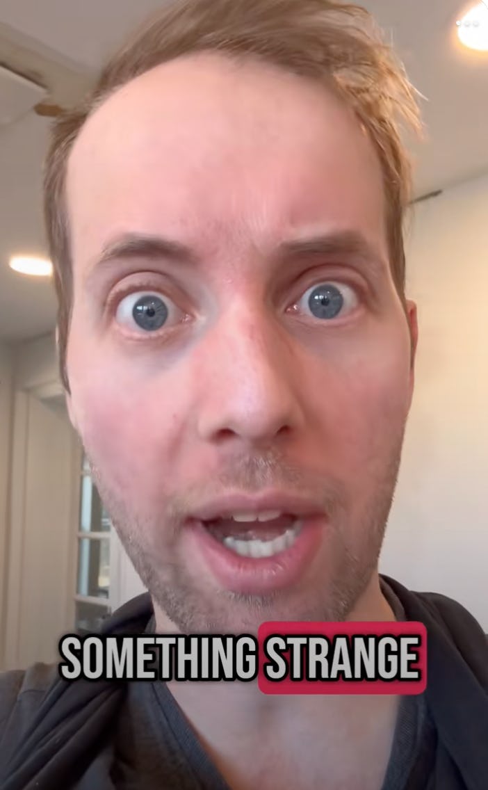 A close-up of a man with wide eyes and an expressive face, appearing surprised or concerned, with text below that reads 