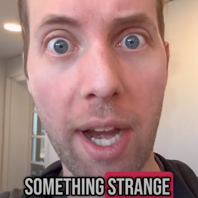 A close-up of a man with wide eyes and an expressive face, appearing surprised or concerned, with text below that reads