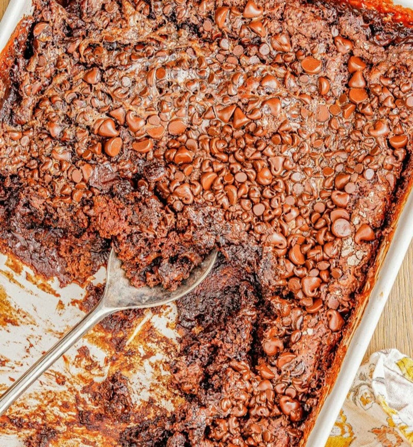 Chocolate cake covered in chocolate chips in a white 9x13 baking dish, in a story about easy chocolate dessert recipes