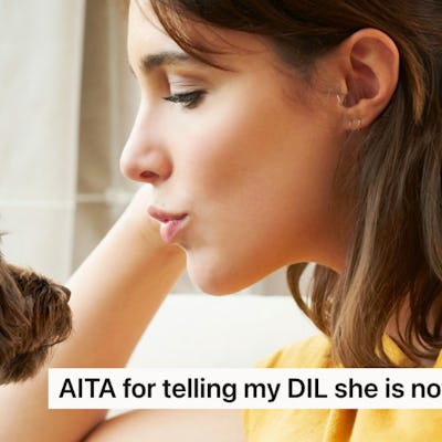 A woman sits indoors, looking intently at a small dog beside her. A caption asks if she is wrong for telling her daughter-in-law she is not a mother.