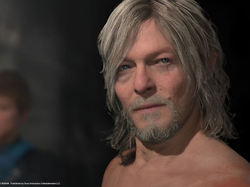 A close-up of a middle-aged man with long, shaggy hair and a beard, looking directly at the camera. ...