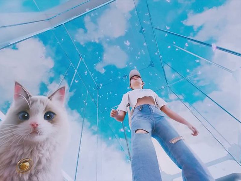 A person wearing casual clothing stands beneath a clear sky in a glass structure, accompanied by a l...