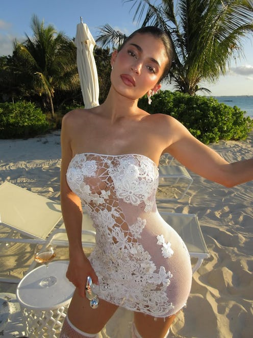 Kylie Jenner wears a see-through white dress.